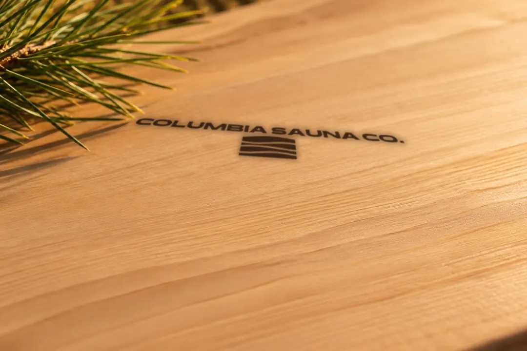 The Columbia Sauna Co. mark burned into a cedar board